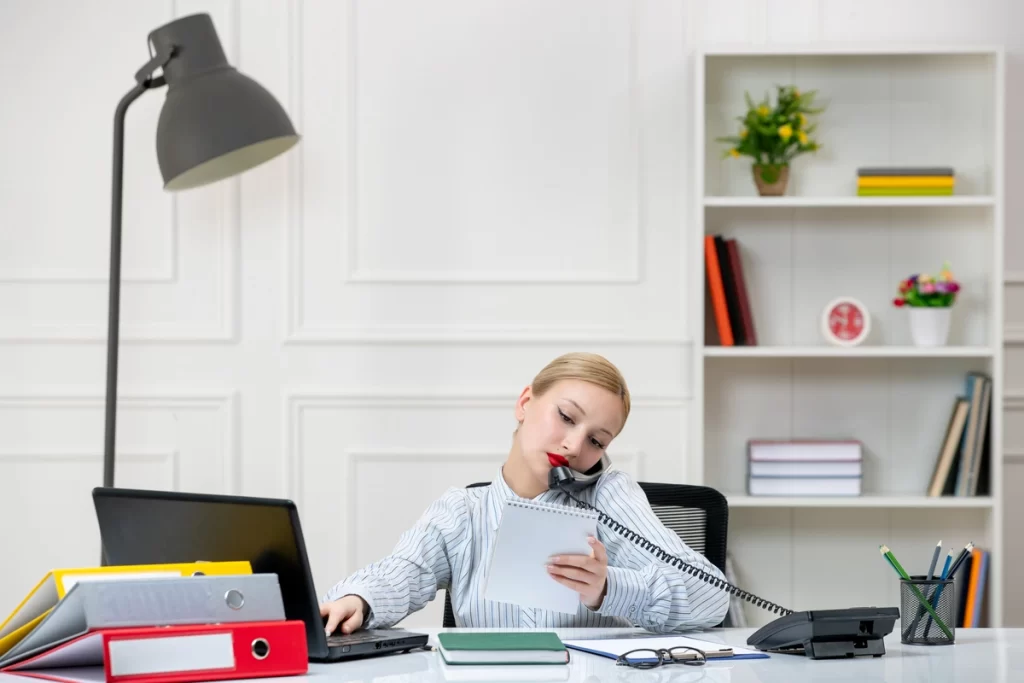 Young girl taking notes during real estate cold calling