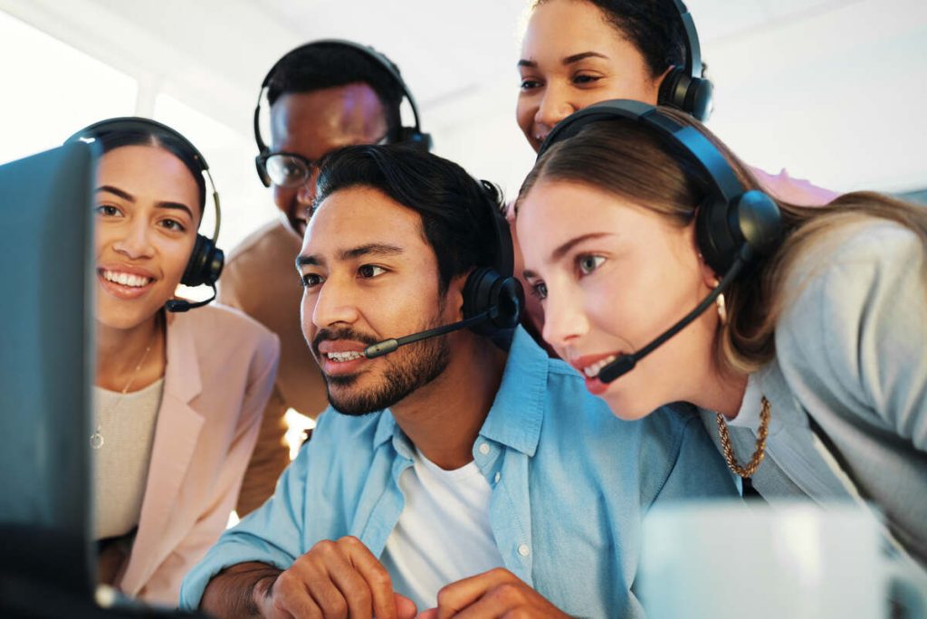 Call center, manager and reading on computer for news of sales, success and excited for online feed.