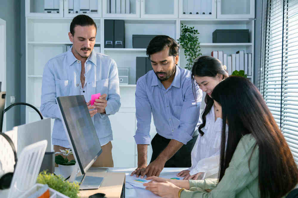 Group of multiethnic young business friends gathered in a modern office conference room and worked as a team.